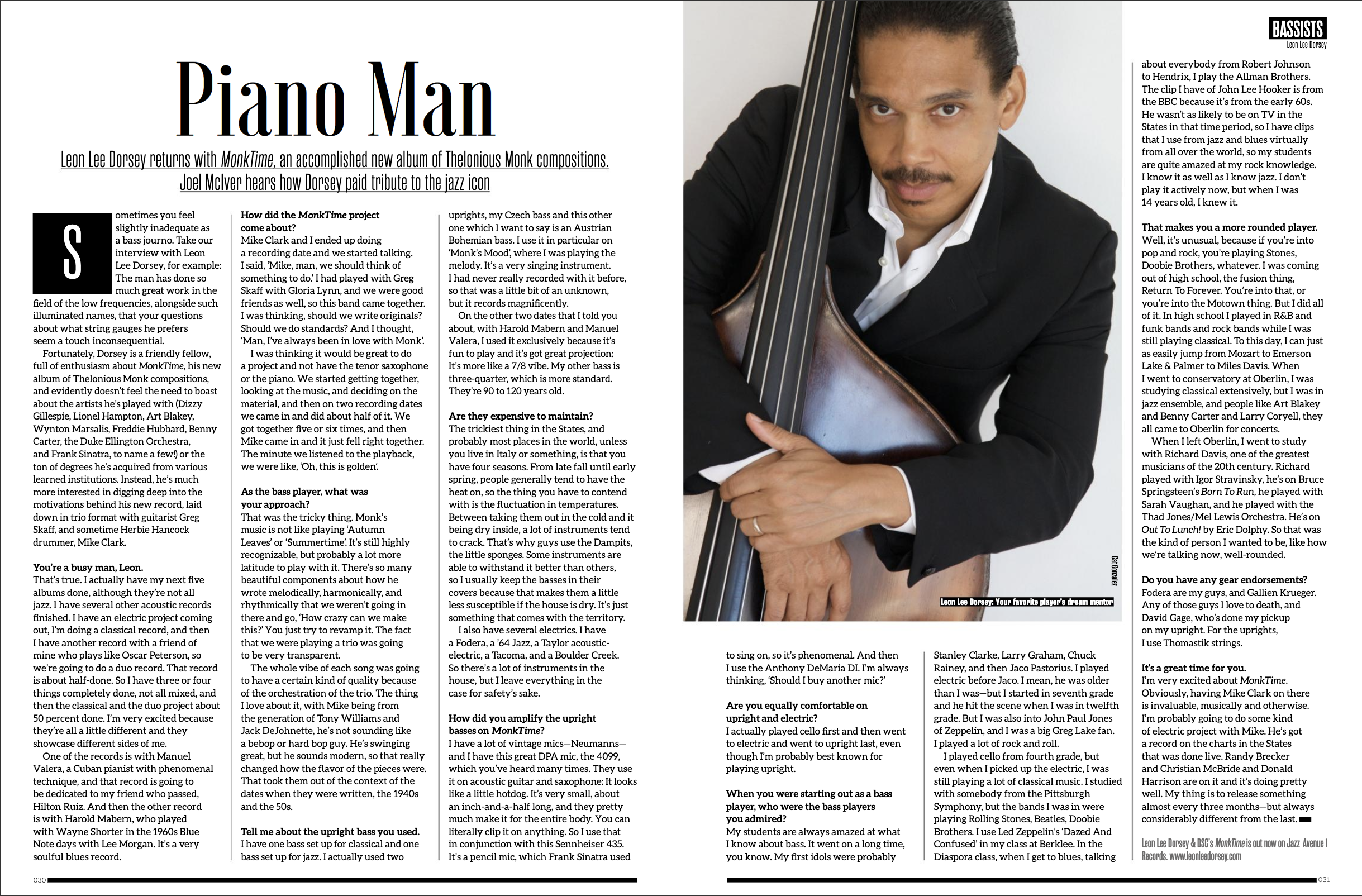 Magazine article featuring a man with a mustache and mustache holding a bass guitar, wearing a black suit and white shirt, with a serious expression.