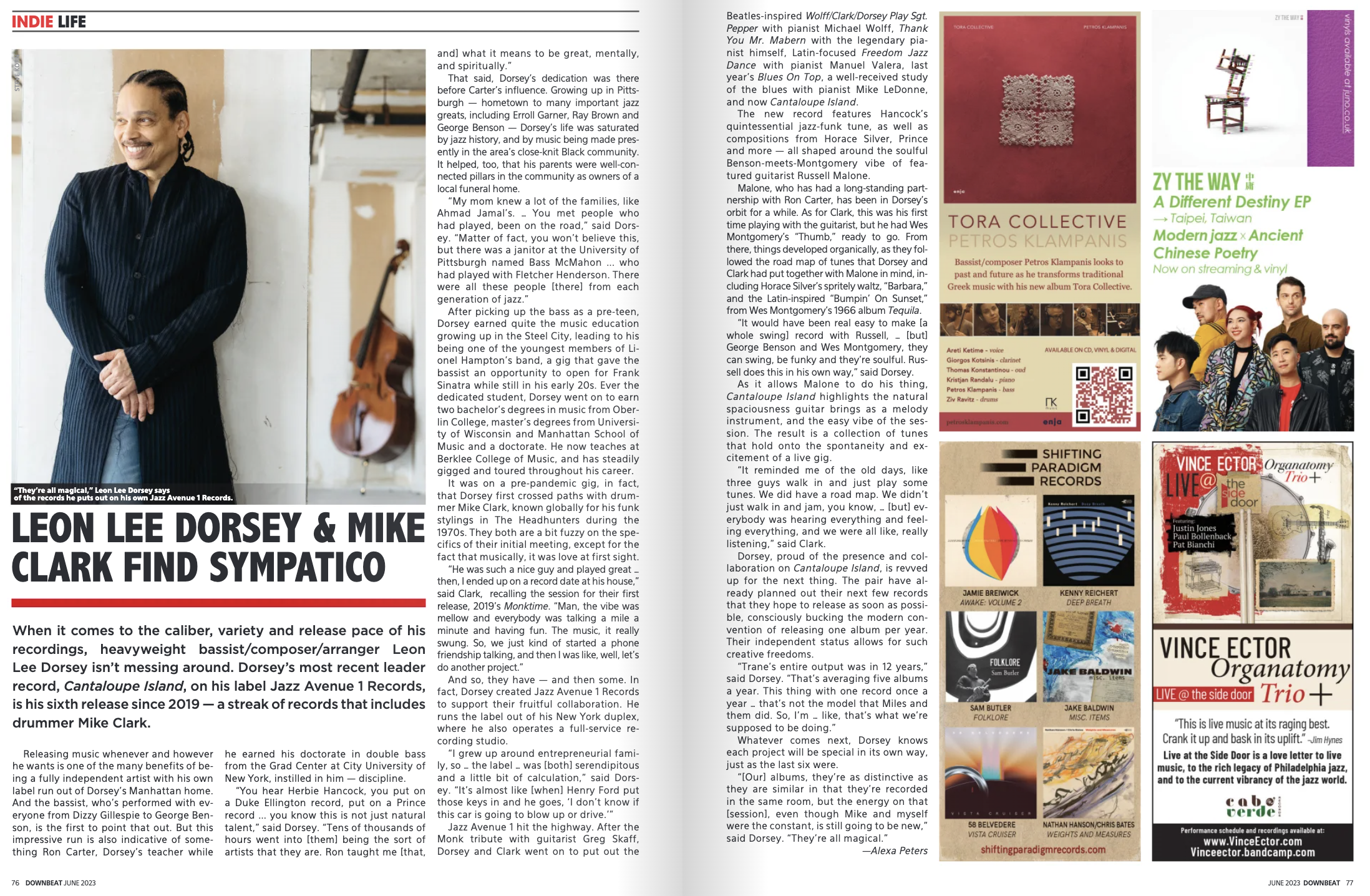 A magazine spread features an interview with music artists Leon Lee Dorsey and Mike Clark, showcasing a large photo of Dorsey in a black pinstripe suit and dreadlocks, smiling with arms crossed, standing indoors next to a bass guitar. The text covers their careers, musical influences, and collaboration. The right page includes advertisements for music albums, events, and a QR code.